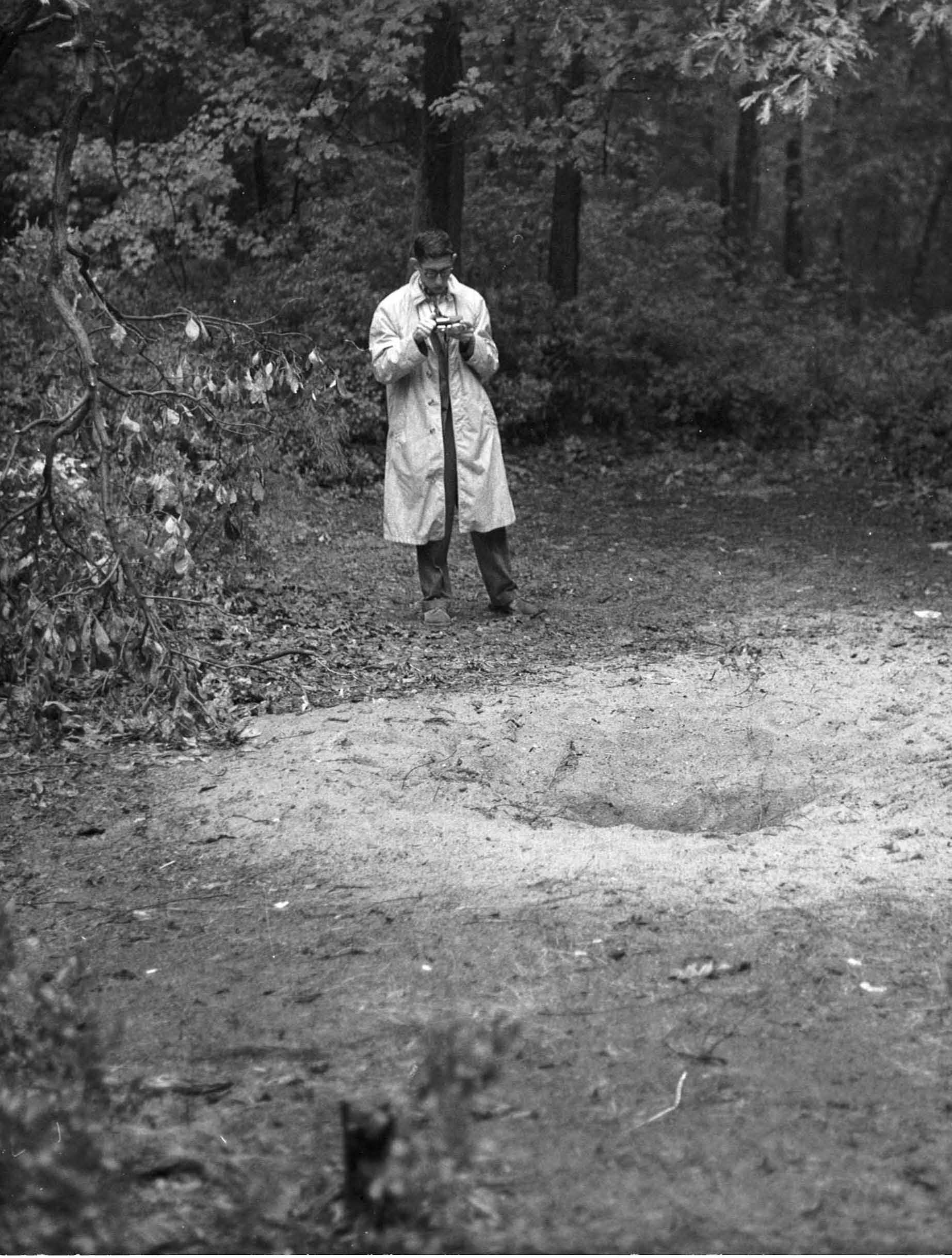 A 16-year-old UFO investigator inspects the "central crater" at Glassboro, NJ. The broken limb of the sassafras tree is on the left. Photo by the Cassel family of Glassboro.